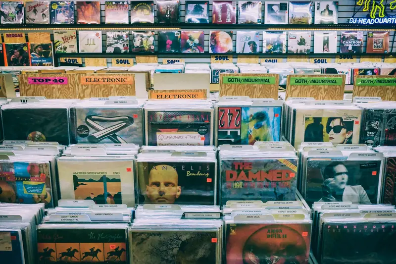A vintage vinyl record display with diverse music genres in a classic music store