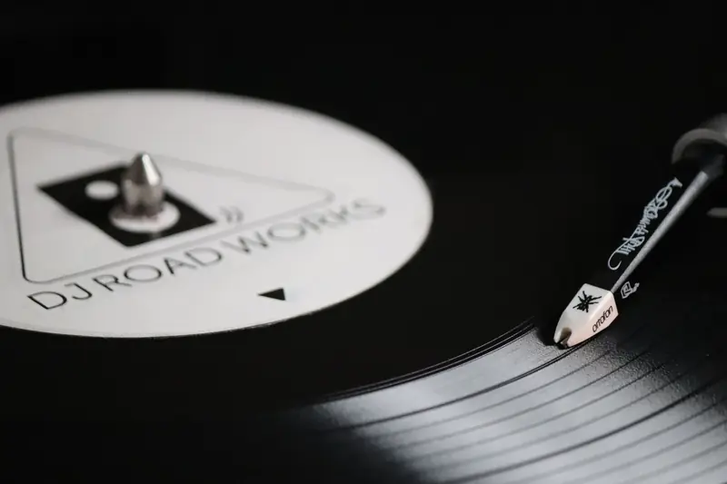 Close-up of a vintage vinyl record spinning on a turntable with DJ Road Works label