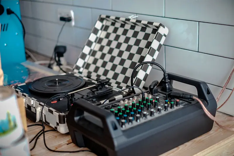 Professional mixer and turntable setup in a modern indoor setting for music production