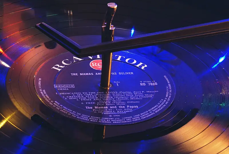 Close-up of an RCA Victor vinyl record playing on a turntable with vibrant lighting