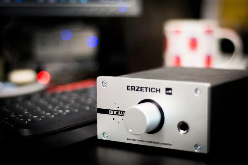 Close-up of a headphone amplifier in a studio setting, showcasing sleek design and advanced technology