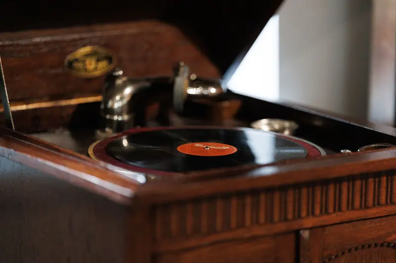 Close-up of a vintage wooden record player with a black vinyl record, evoking nostalgia