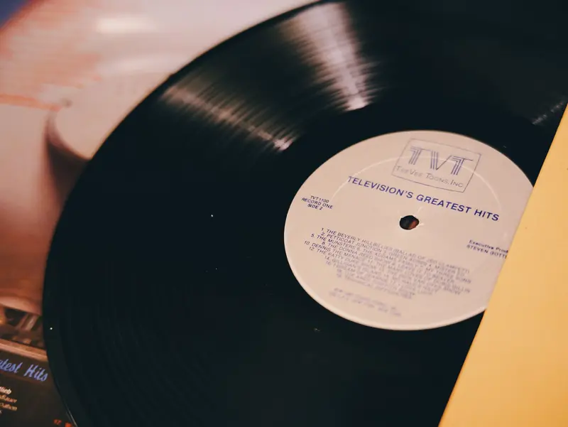 A vintage vinyl record titled 'Television's Greatest Hits' on a turntable